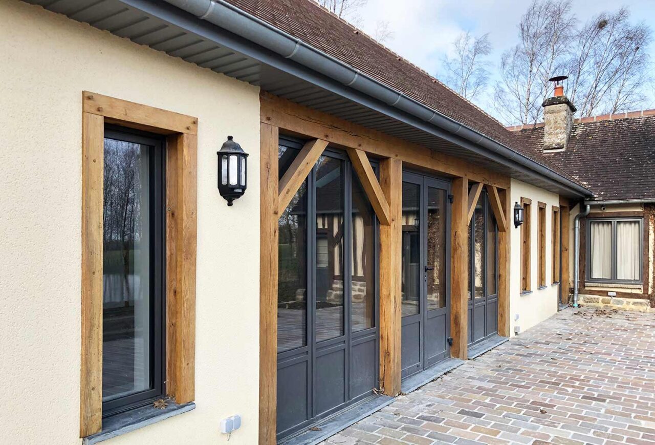 Close view of the front of the property. Showing the wooden features around the doors and windows.