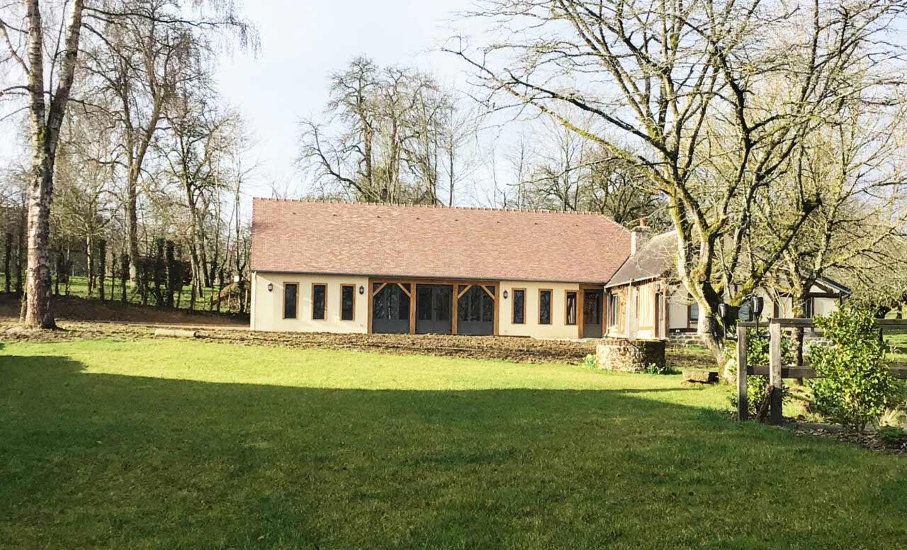 Newly built pool house, rendered walls with a double door and windows on each side. 3 small windows on each side of the door.