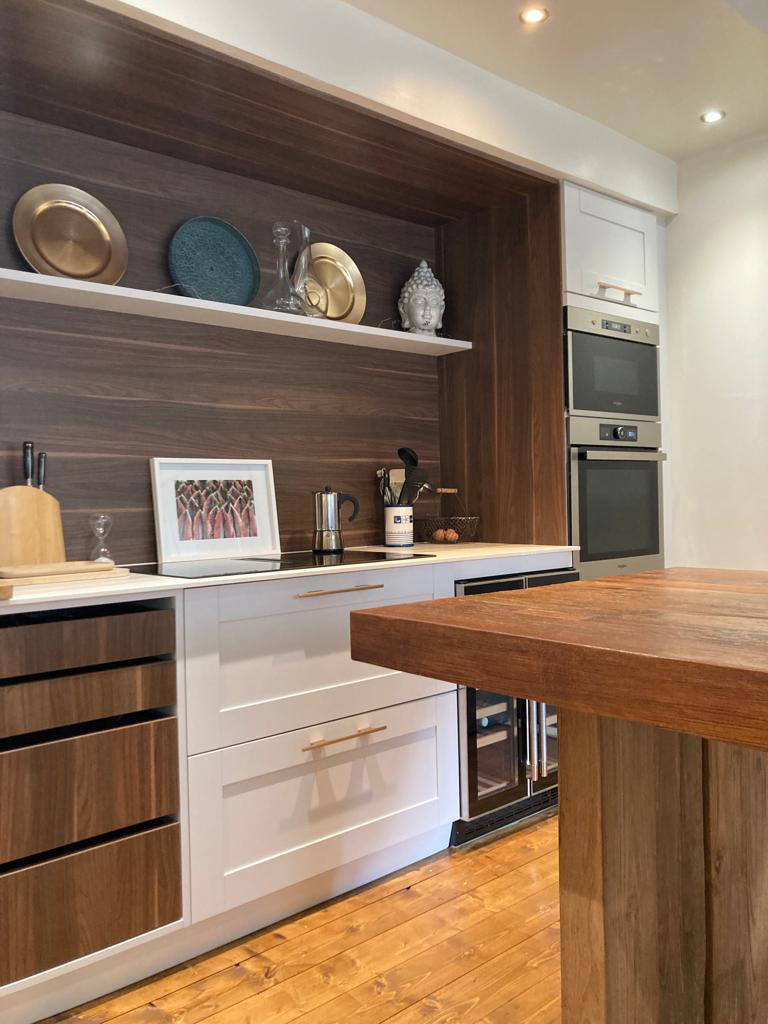 View of the new kitchen cupboards showing the built in oven & microwave.