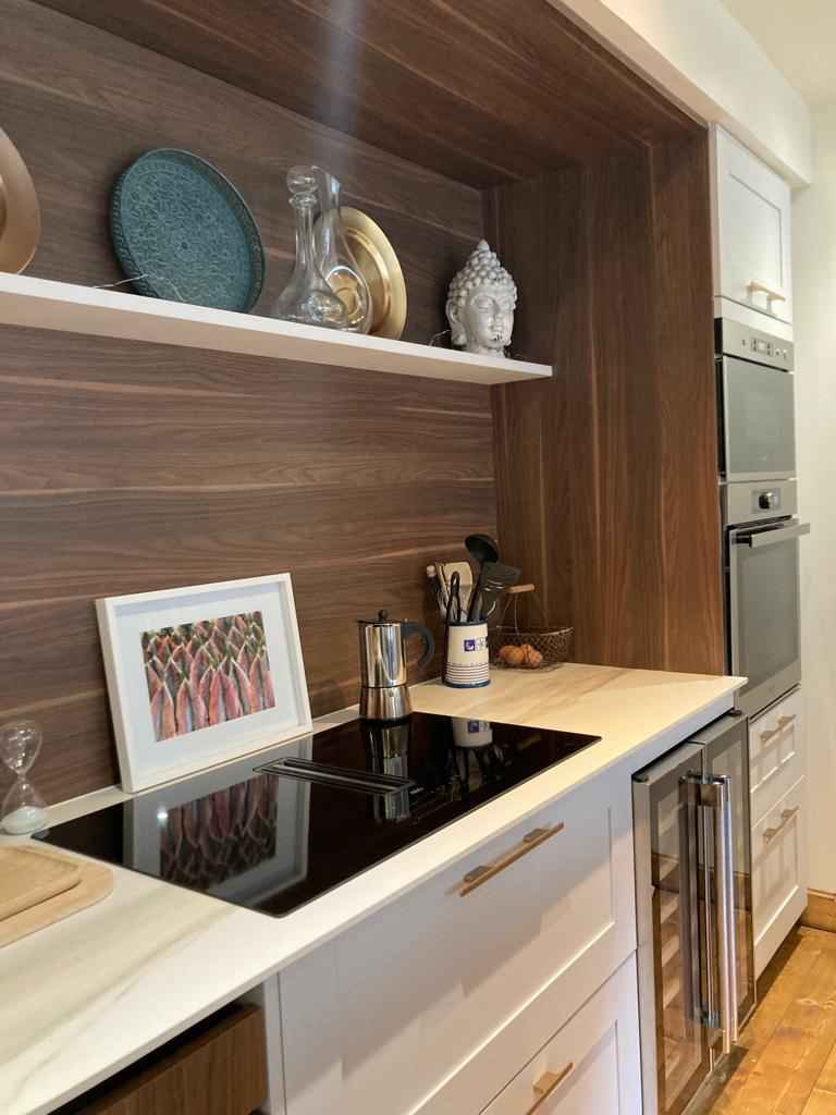 View of the hobs. A small shelves installed above the hobs and counter place.