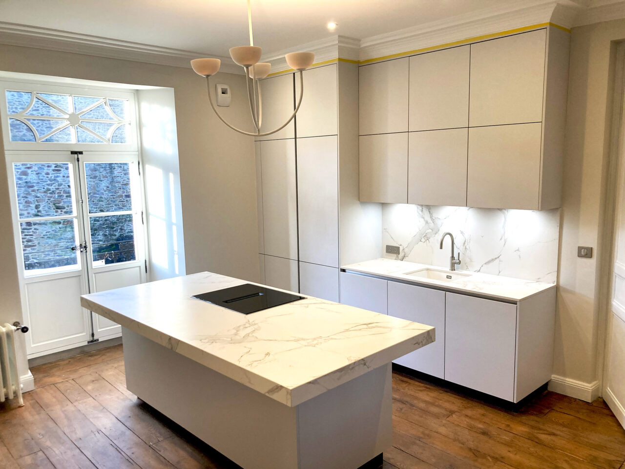 View of new kitchen installed, showing the kitchen island and the view of the remparts from the balcony doors.