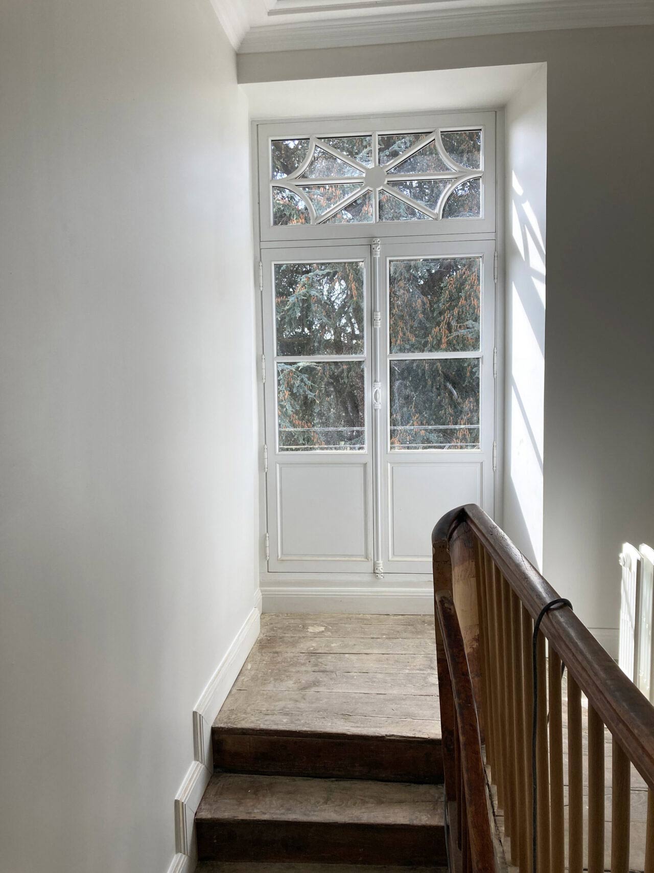 New bespoke balcony door, painted white.