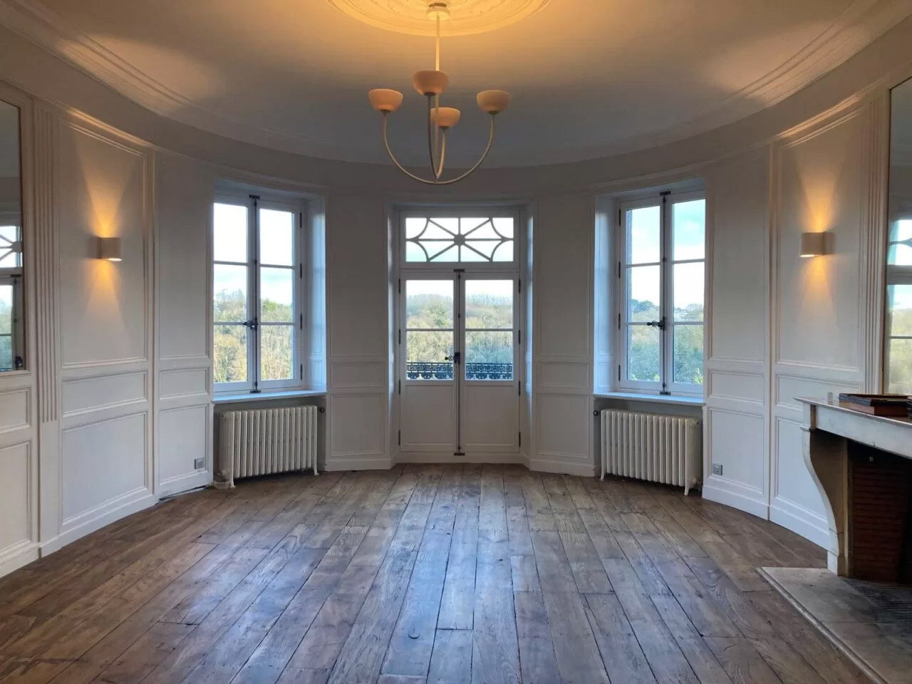 Oval room, freshly painted white, wooden floors have been refresh.