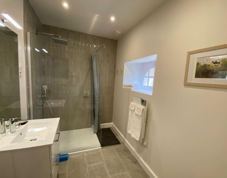 View of ensuite showing the shower and the sink.