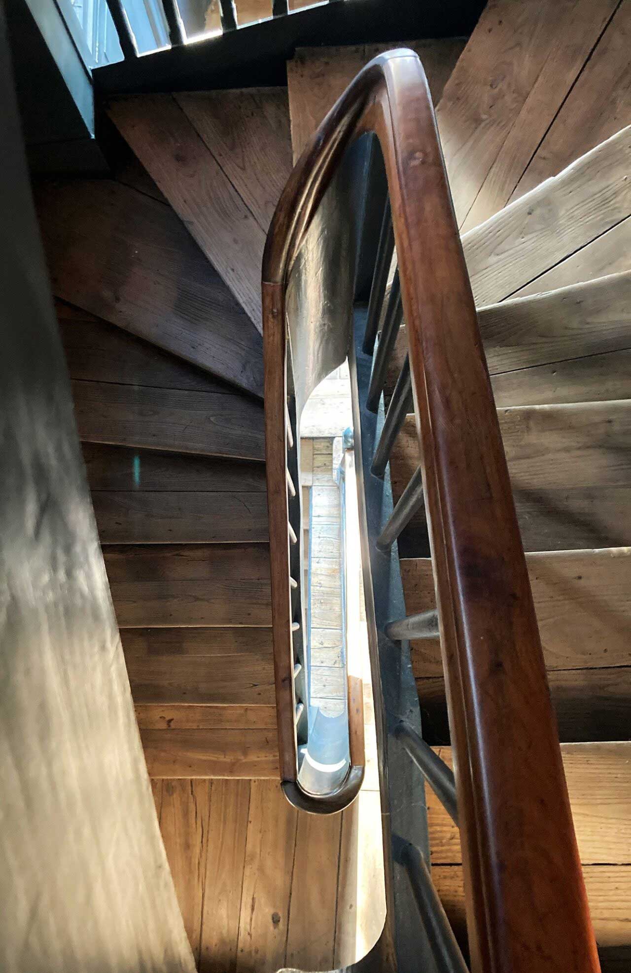 Wood stairs going down from the 2nd floor to the ground floor.
