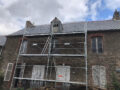 View of the front of the house with the scaffolding in front, new roof has already been installed.