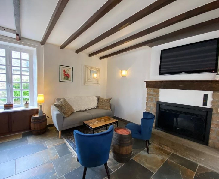 View of the sofa and the both arm chairs in the living room.